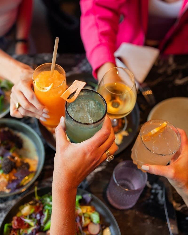 Cocktail glasses meeting in a toast